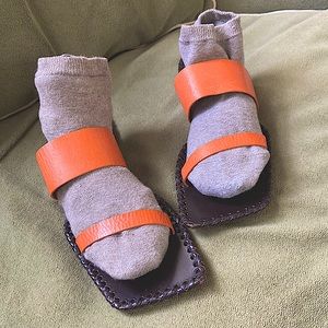 Flat, neutral orange, strap, sandals on leather soles